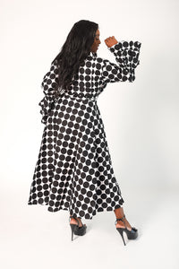 black and white polka dot wrap style dress with tiered ruffle sleeves. Dress has pockets.