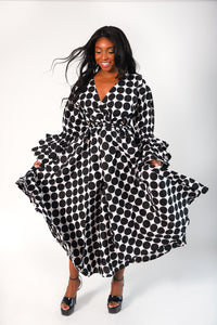 black and white polka dot wrap style dress with tiered ruffle sleeves. Dress has pockets. 